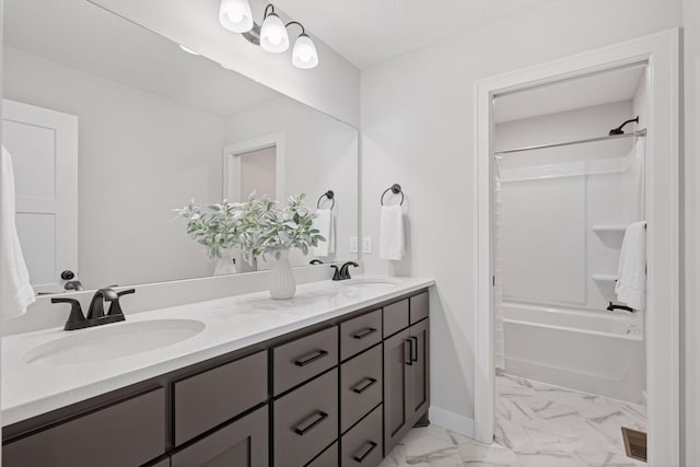 full bath featuring double vanity, marble finish floor, shower / bath combination, and a sink