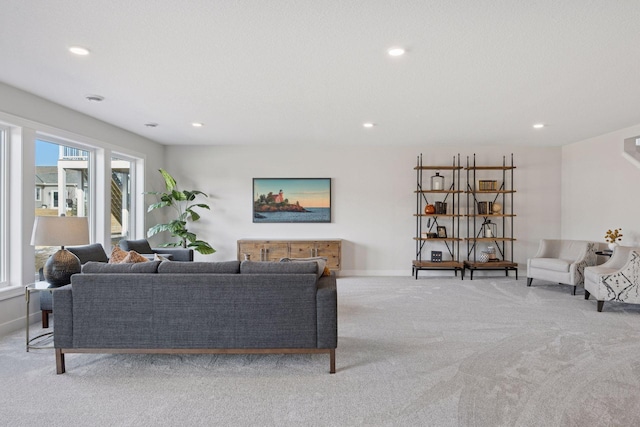 living area with baseboards, carpet, and recessed lighting