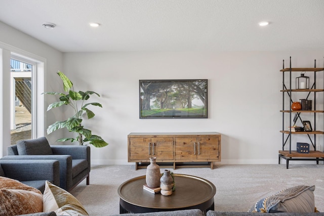 living area with carpet floors, recessed lighting, a textured ceiling, and baseboards