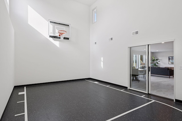 view of basketball court with basketball hoop and plenty of natural light