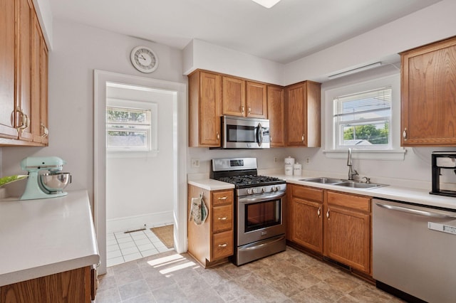 1503 Sheridan Ave N, Minneapolis, MN 55411 - kitchen with stainless steel appliances, light countertops, and brown cabinetry