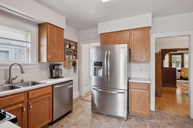 1503 Sheridan Ave N, Minneapolis, MN 55411 - kitchen with appliances with stainless steel finishes, open shelves, brown cabinetry, and light countertops