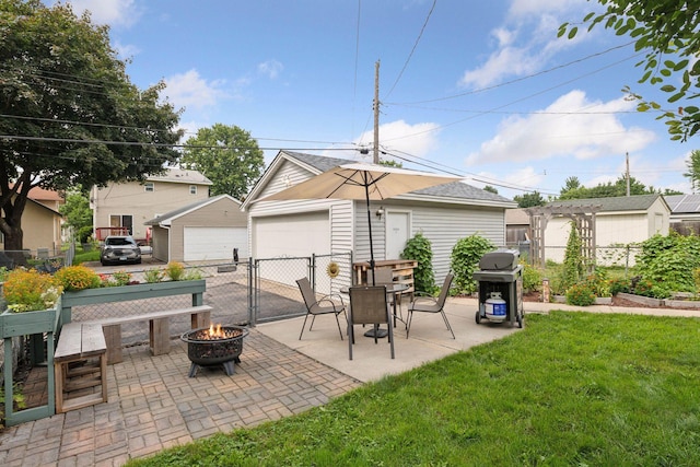 1503 Sheridan Ave N, Minneapolis, MN 55411 - view of patio with an outdoor fire pit, a grill, a detached garage, and an outdoor structure