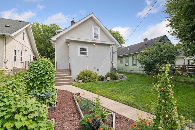 1503 Sheridan Ave N, Minneapolis, MN 55411 - back of house featuring a garden, stucco siding, and a chimney