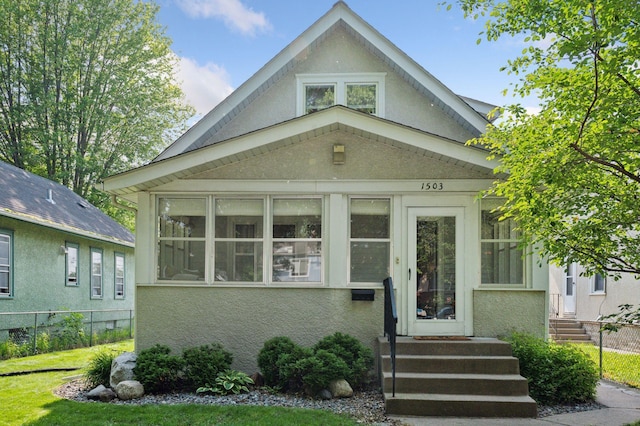 1503 Sheridan Ave N, Minneapolis, MN 55411 - view of front facade with stucco siding and a sunroom