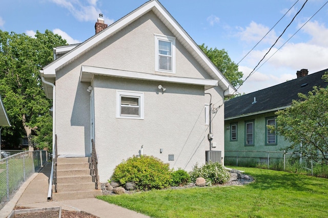 1503 Sheridan Ave N, Minneapolis, MN 55411 - view of property exterior featuring stucco siding and a chimney