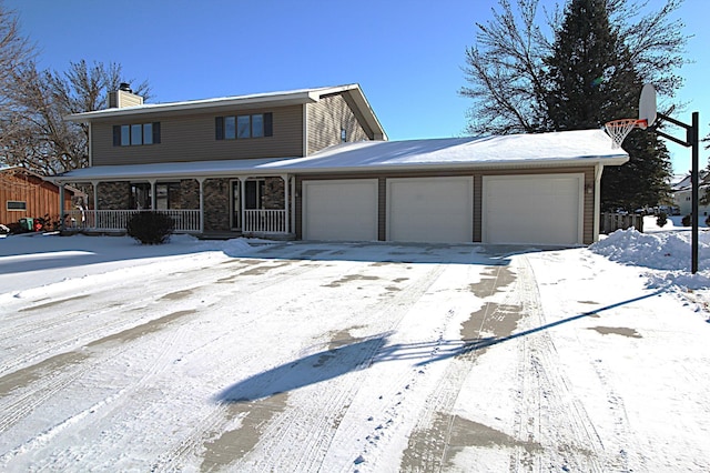 view of front of property featuring a porch and a garage