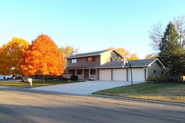 view of front of home featuring a garage and a front lawn