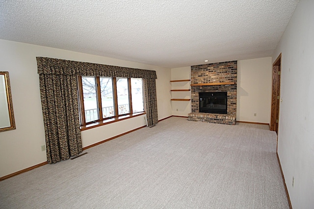 unfurnished living room with carpet floors, a textured ceiling, and a fireplace