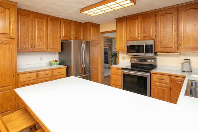 kitchen featuring appliances with stainless steel finishes, a breakfast bar, and sink