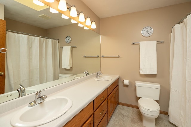 bathroom with walk in shower, vanity, and toilet