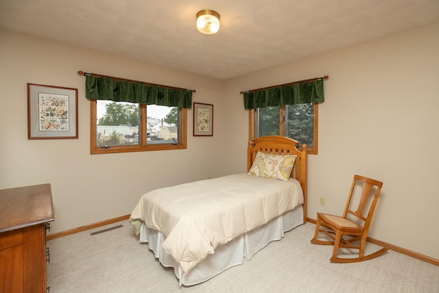 bedroom featuring light carpet