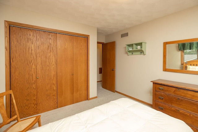 bedroom with light colored carpet and a closet