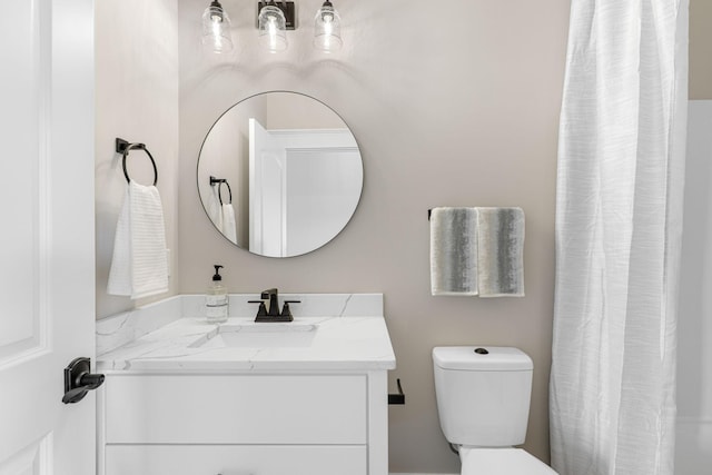 bathroom with toilet and oversized vanity