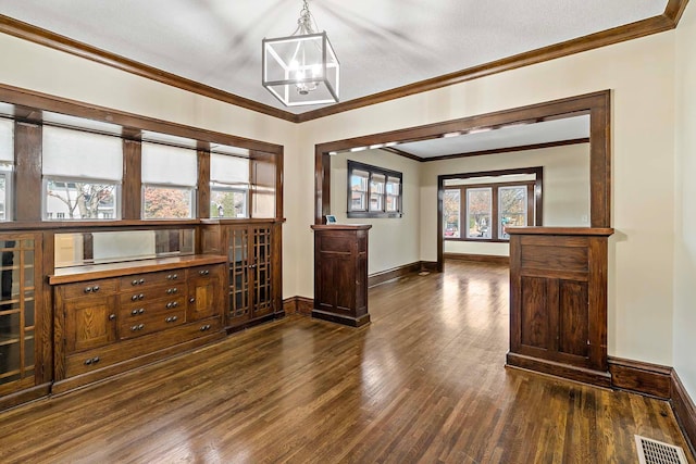 living room with a notable chandelier, ornamental molding, a textured ceiling, and dark hardwood / wood-style floors