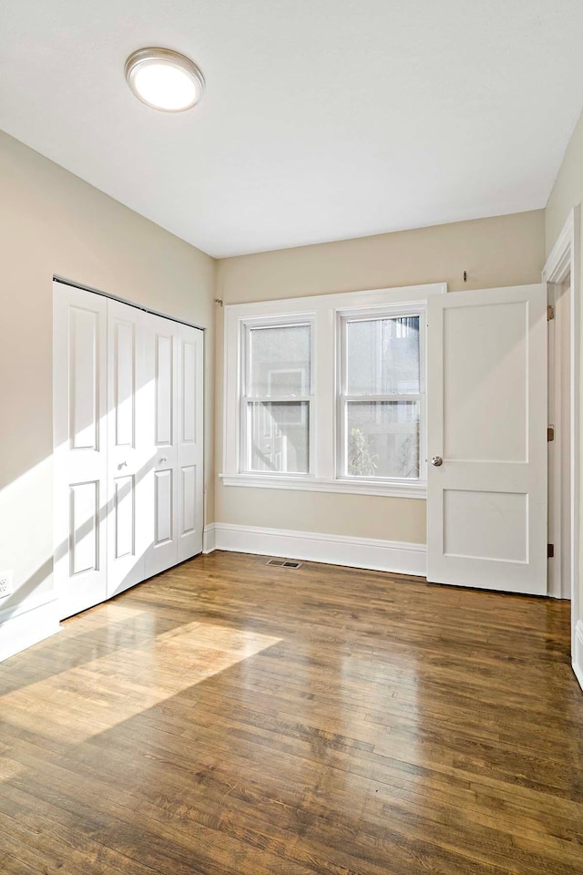 spare room with wood-type flooring