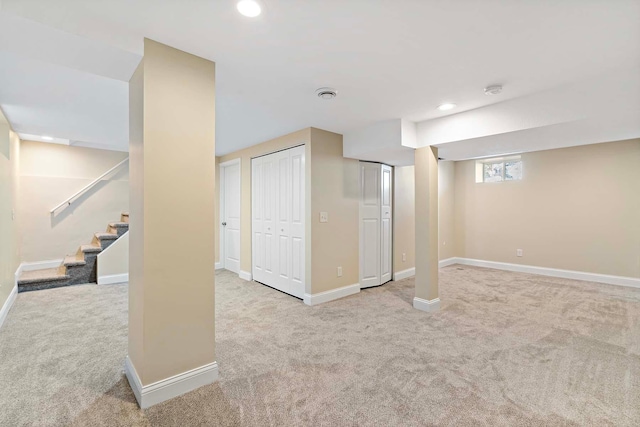 basement featuring light carpet