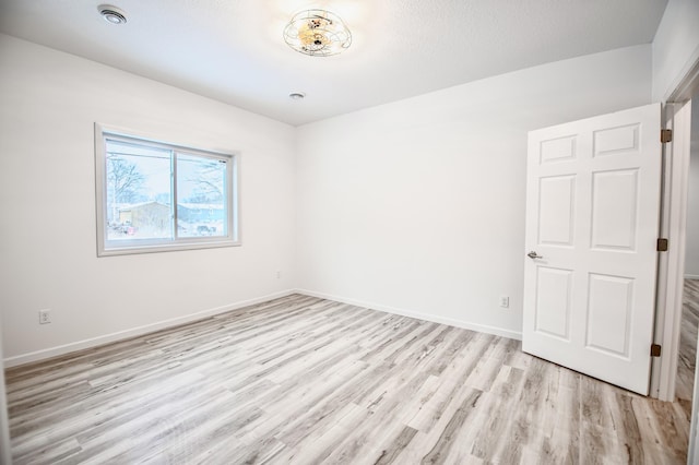 unfurnished room featuring light hardwood / wood-style flooring