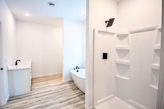 bathroom featuring separate shower and tub, vanity, and hardwood / wood-style flooring