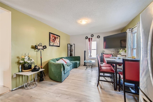 living room featuring a textured ceiling and light hardwood / wood-style floors