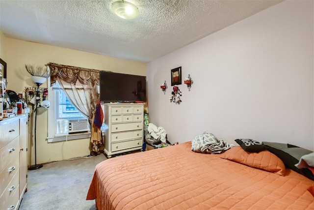 bedroom featuring a textured ceiling and light colored carpet