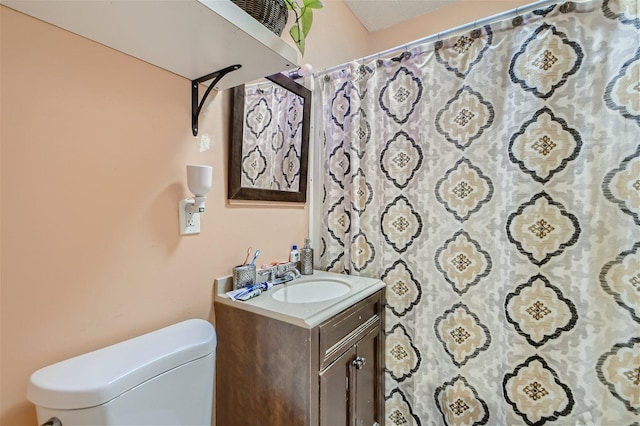 bathroom featuring toilet and vanity with extensive cabinet space