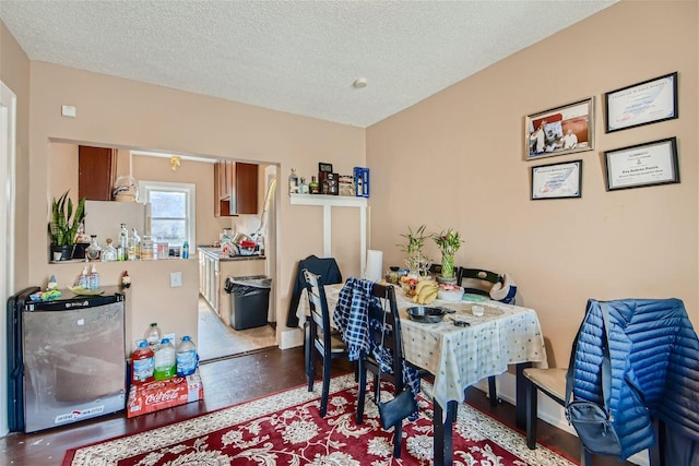 dining space featuring hardwood / wood-style floors and a textured ceiling