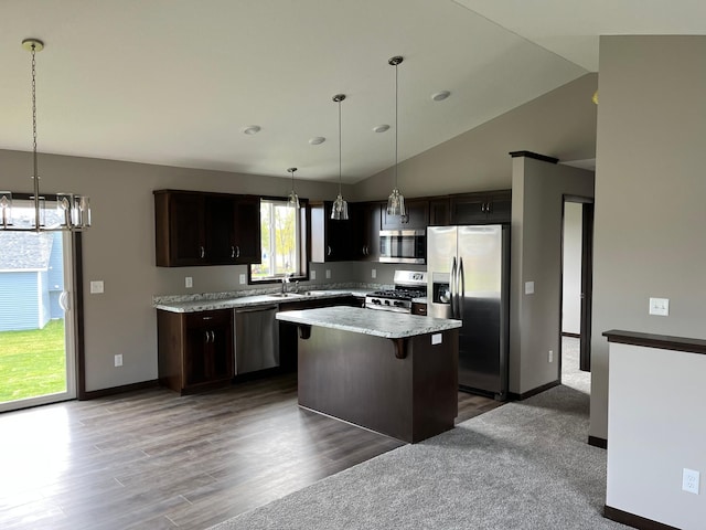 kitchen with hanging light fixtures, a center island, stainless steel appliances, a notable chandelier, and dark brown cabinets