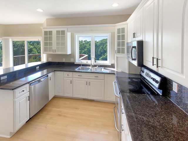 kitchen featuring light wood-type flooring, white cabinetry, stainless steel appliances, and sink