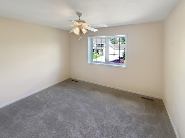 carpeted spare room with ceiling fan