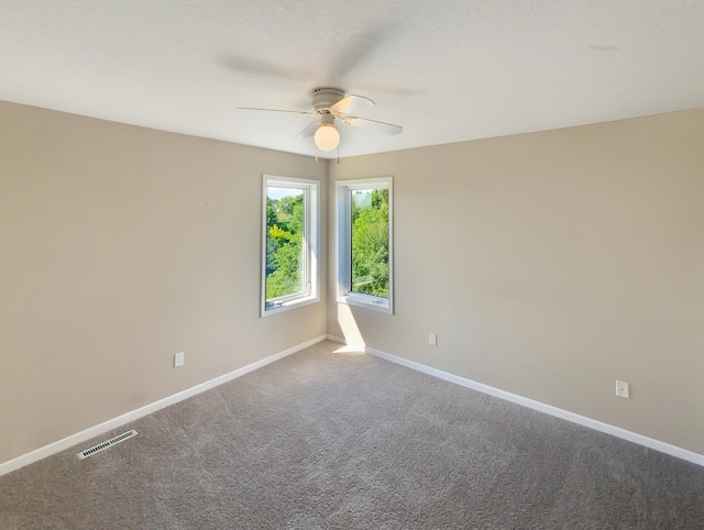 empty room with carpet and ceiling fan