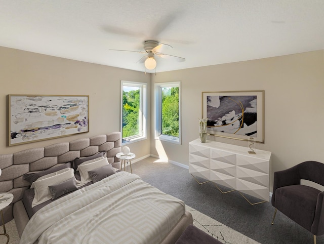 bedroom featuring ceiling fan and carpet