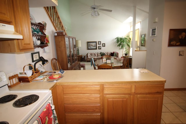 kitchen with ceiling fan, light tile flooring, stove, vaulted ceiling, and kitchen peninsula