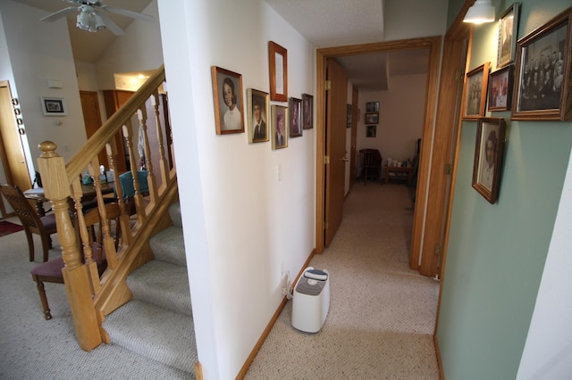 hall featuring light colored carpet