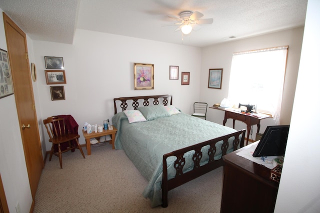 bedroom featuring carpet, ceiling fan, and a textured ceiling