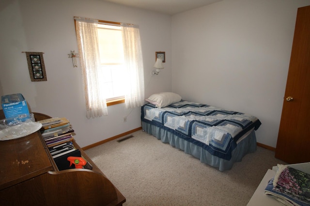 bedroom featuring light carpet