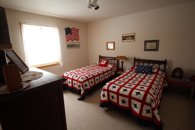 carpeted bedroom featuring a textured ceiling