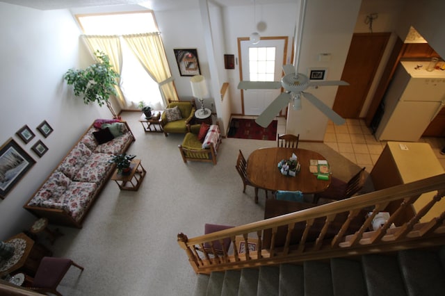 tiled living room featuring ceiling fan