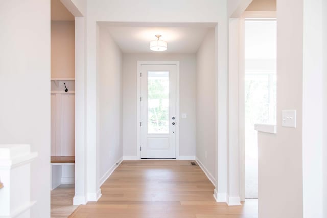 doorway to outside with light wood-type flooring