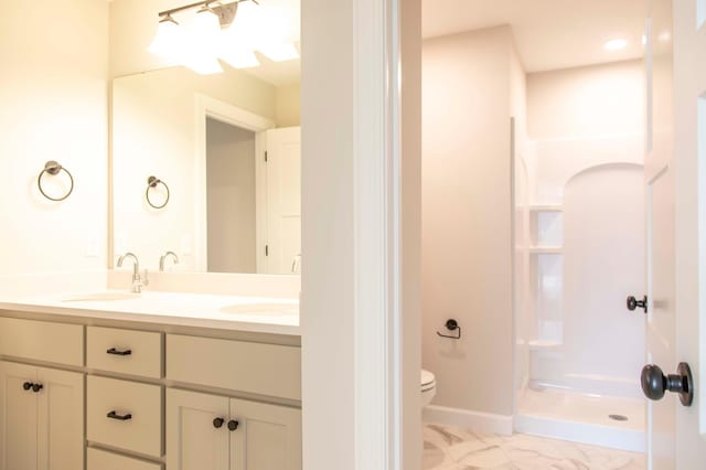 bathroom with walk in shower, vanity, toilet, and tile patterned floors