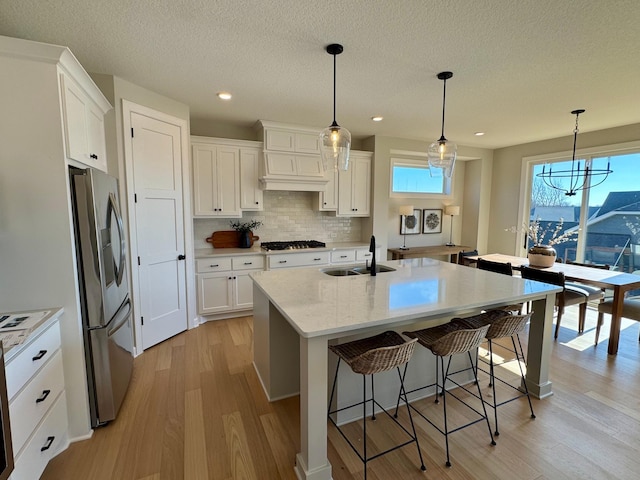 kitchen with white cabinetry, stainless steel appliances, and a sink