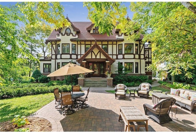 rear view of house featuring outdoor lounge area and a patio