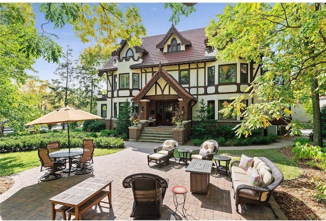 back of house featuring a fire pit and a patio