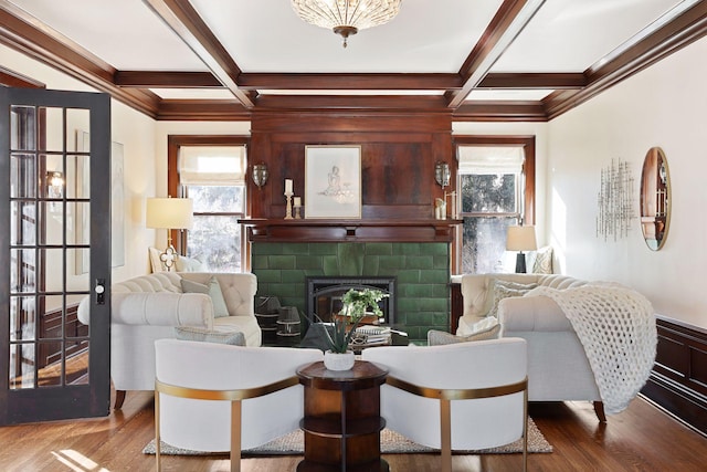 living area featuring a wealth of natural light, hardwood / wood-style floors, beamed ceiling, and coffered ceiling