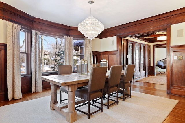 dining area featuring an inviting chandelier and light hardwood / wood-style floors