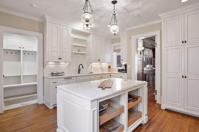 kitchen with hanging light fixtures, white cabinets, and a center island