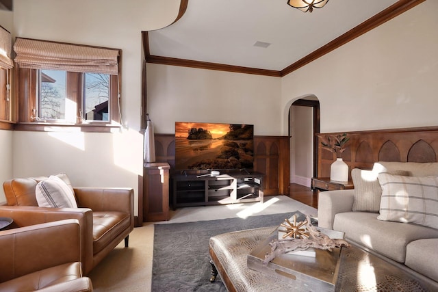 carpeted living room featuring ornamental molding