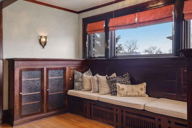 interior space featuring a wealth of natural light, light hardwood / wood-style flooring, and crown molding