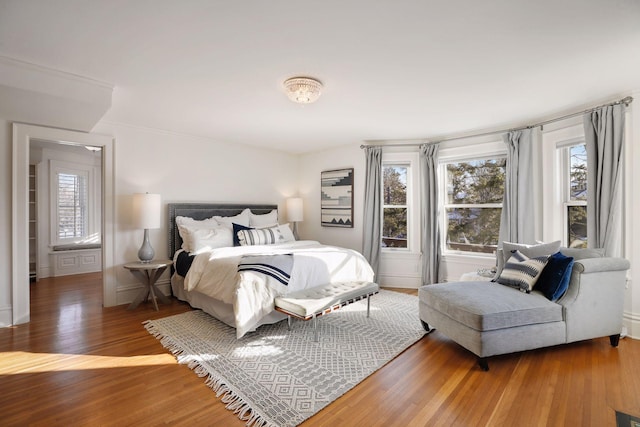 bedroom with crown molding and hardwood / wood-style floors