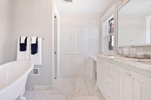 bathroom with vanity and a bathing tub